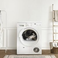 Washing machine in a minimal laundry room interior design Washing machine in a minimal laundry room interior design